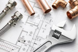 Plumbing tools on top of a blueprint.
