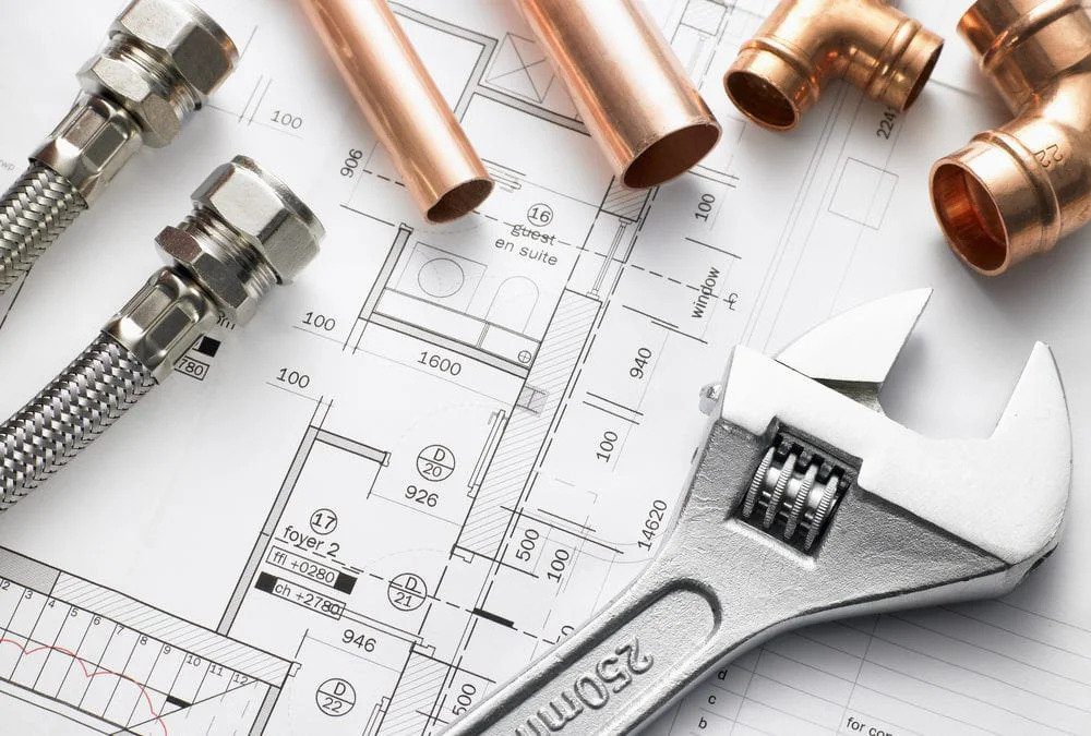 Plumbing tools on top of a blueprint.