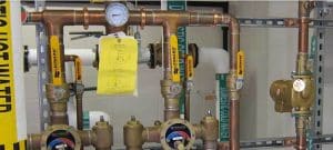 A group of pipes and valves in a room.
