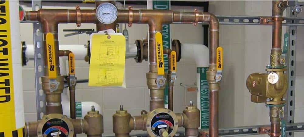 A group of pipes and valves in a room.